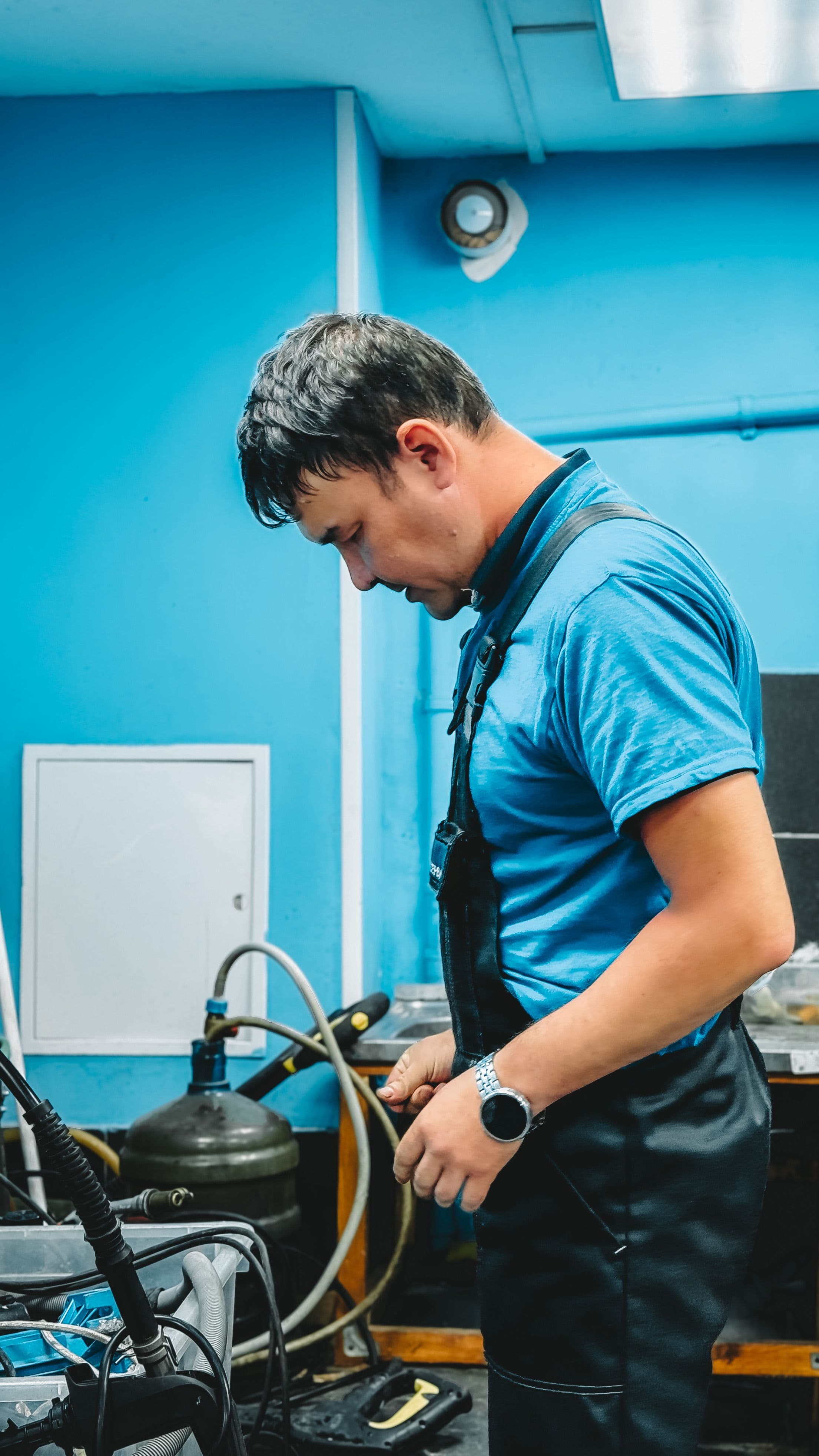 Technician working on heating equipment in a utility room