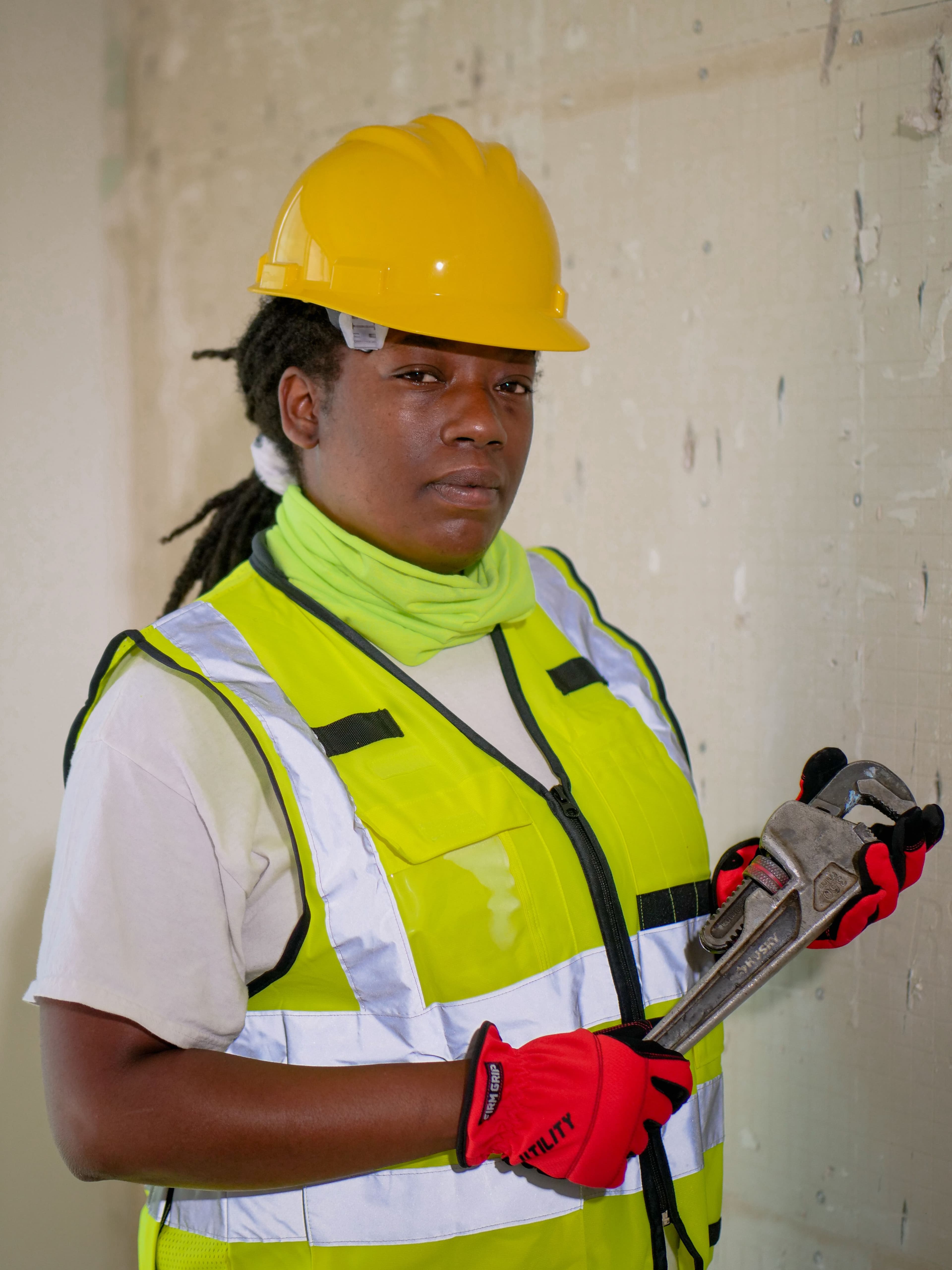 Confident plumbing technician holding a pipe wrench, ready for a service call